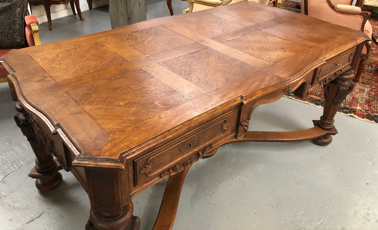 Beautifully carved 19th century French oak Bureau Plat. With a lovely parquetry top and two drawers and decorative carved legs this piece is definitely one to look at . In good original detailed condition.