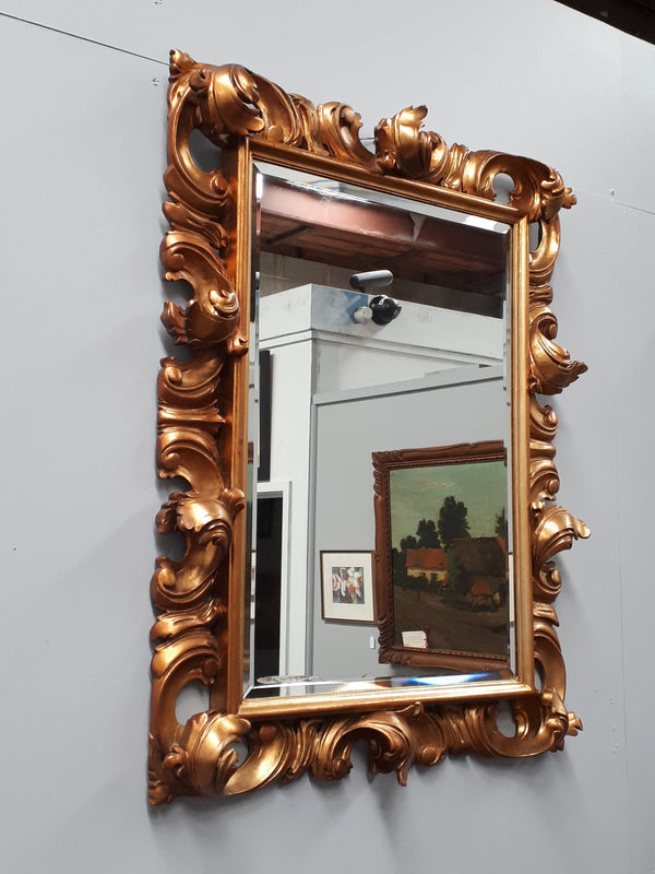 Early 20th Century French Rococo style gilt bevelled wall mirror. It has been sourced from France and is in good original condition. Circa 1920
