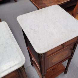 Pair of white marble topped Louis 16th style bedside cabinets consisting of one drawer and one cupboard.  Inlaid with burr walnut and has decorative mounts. They have been sourced from France and are in good original condition.