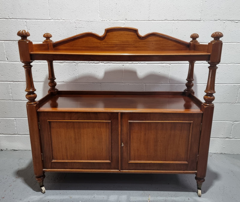 Victorian Mahogany Dumb Waiter with two cupboards, original casters in good detailed condition.