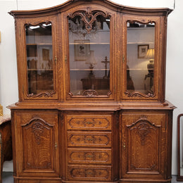 Impressive French Oak Louis 14th Style Display and Sideboard. It has 4 drawers, 2 bottom cupboards with 6 total shelves and 3 display doors with 3 shelves.  In good, detailed condition.