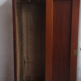 Unusual Victorian Flame Mahogany side wardrobe with side door. It has full hanging and six hooks. The wardrobe opens from a side door which can be locked with its key and has a markers mark stamp on the door. It is in good original condition.