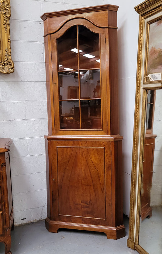 Practical Walnut corner cabinet with display and storage. Two shelf glass display on top and single shelf cupboard below. Sourced locally and in good original detailed condition.