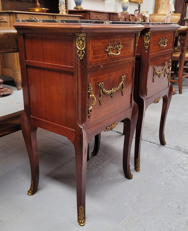 Appealing Louis XV style high quality bedside cabinets with black Portoro marble top and bronze mounts. They have been sourced from France and are in good original condition.