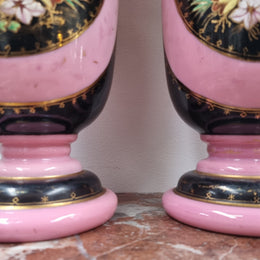 Late Victorian pink and hand painted, enameled pair of vases with some ware to enameling. It is in good original condition.