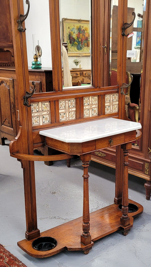 Late Victorian Arts and Crafts style marble top hall stand. Features three attractive tiles, original hooks and single drawer. In good original condition.