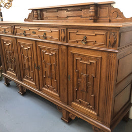 Beautiful carved French Oak four-door buffet with three drawers and lots of room for storage in good original detailed condition.
