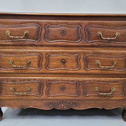 French Provincial Oak three drawer wooden top commode. It has elegant carvings and handles. It has been sourced from France and is in good original detailed condition.