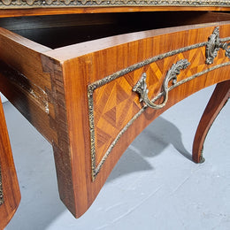 An impressive French kingwood and ormolu mounted bureau plat. It has a brown tooled leather writing surface, three decorated frieze drawers to the shaped apron with foliate swing handles and well cast figural mounts. Beautiful cabriole legs with decorative ormolu mounts and trims throughout. In good original detailed condition.