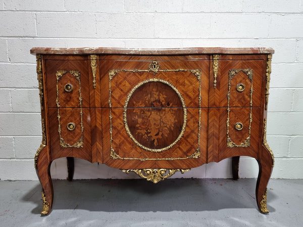 Stunning transitional French Marquetry inlaid marble top commode. It has lovely ormolu decorative mounts and an amazing thick marble top. Sourced from France and is in good original detailed condition.