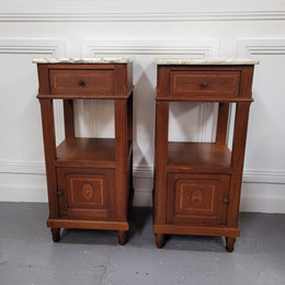 Pair of Antique French Oak Louis XVI style marble top bedside cabinets. They have decorative inlay and have been sourced from France. They are in good original detailed condition.
