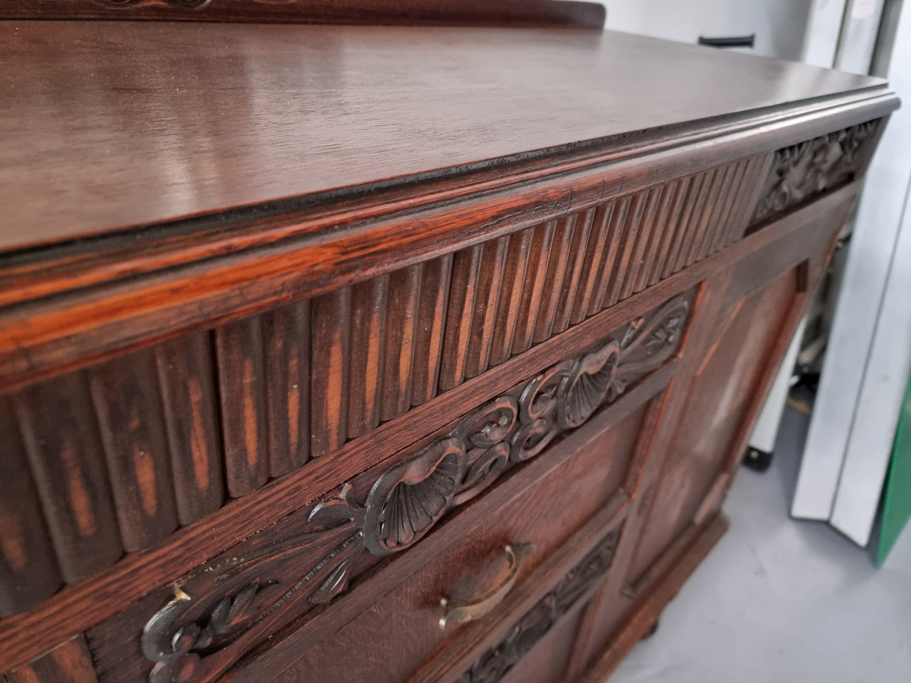Art Deco Tudor style Oak sideboard with decorative carved detail. Plenty of storage space with two cupboards and four drawers. It has been sourced locally and is in good original detailed condition.