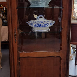 Petite French Louis XV style Walnut display cabinet with two glass shelves that can be adjusted and added storage at the bottom . In very good original detailed condition.