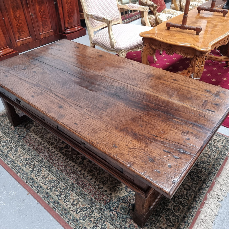 Impressive large size rustic French Oak coffee table with two drawers on a stretcher base. In good original detailed condition and sourced from France.