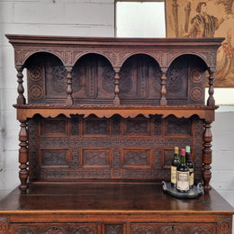 Impressively carved 18th Century English Oak kitchen dresser in 17th Century Jacobean style. It is in good original detailed condition and has been sourced from France.
