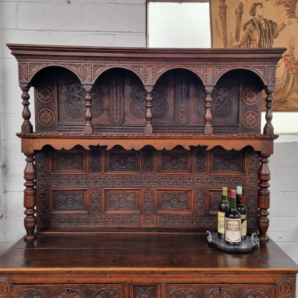 Impressively carved 18th Century English Oak kitchen dresser in 17th Century Jacobean style. It is in good original detailed condition and has been sourced from France.