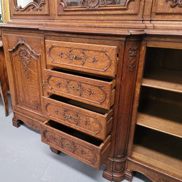 Impressive French Oak Louis 14th Style Display and Sideboard. It has 4 drawers, 2 bottom cupboards with 6 total shelves and 3 display doors with 3 shelves.  In good, detailed condition.