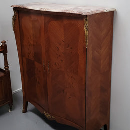 French Louis 15th style Kingwood marquetry inlaid two door cupboard with a beautiful marble top. It has three adjustable shelves and decorative ormolu trim. It has been sourced from France and is in good original detailed condition.