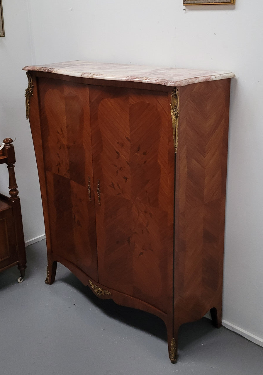 French Louis 15th style Kingwood marquetry inlaid two door cupboard with a beautiful marble top. It has three adjustable shelves and decorative ormolu trim. It has been sourced from France and is in good original detailed condition.