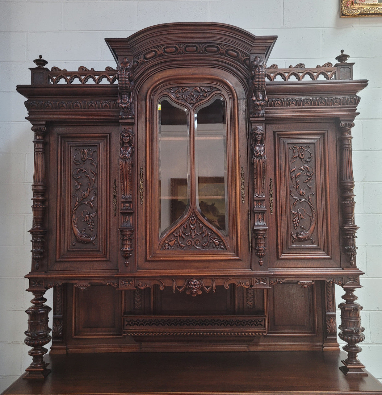 Spectacular French Antique Walnut Renaissance Style buffet with amazing detailed carvings. Plenty of storage space with five cupboards and two large drawers. The three top cupboards open up to two adjustable shelves in each section and the two bottom drawers open up to one large fully adjustable shelve. In good original detailed condition. Circa 1860.