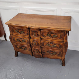 French Antique Louis XIV style Oak wooden top commode. It has a stunning serpentine bombe shape front along with amazing handles and carvings. It comes with three beautiful keys as pictured and comes with working locks. It has been sourced from France and in good original detailed condition.