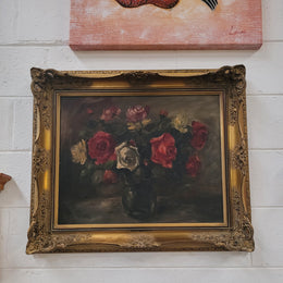 Beautiful gilt framed and signed oil on board depicting roses in floral arrangement. It is in good original detailed condition.