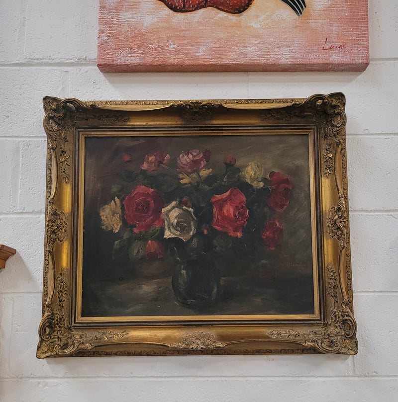 Beautiful gilt framed and signed oil on board depicting roses in floral arrangement. It is in good original detailed condition.