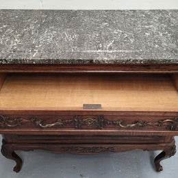 French Oak Louis XV style marble top chest of three drawers. It has beautiful carvings on the drawers with lovely decorative handles all toped with a stunning black and white marble top. In good original detailed condition.