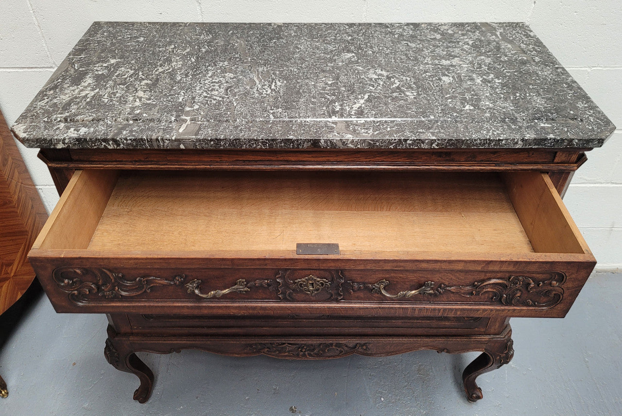 French Oak Louis XV style marble top chest of three drawers. It has beautiful carvings on the drawers with lovely decorative handles all toped with a stunning black and white marble top. In good original detailed condition.