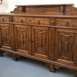 Beautiful carved French Oak four-door buffet with three drawers and lots of room for storage in good original detailed condition.