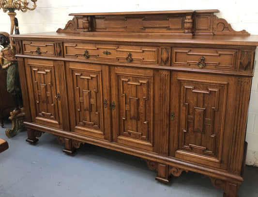 Beautiful carved French Oak four-door buffet with three drawers and lots of room for storage in good original detailed condition.