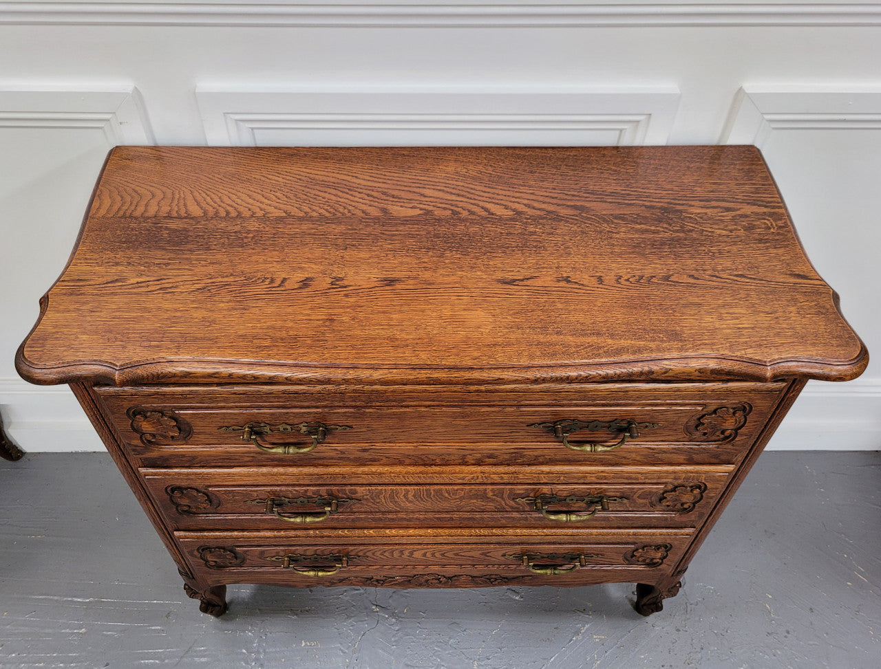 French Louis XV style Oak three drawer chest with wooden top. It has been sourced from France and is in good original detailed condition.