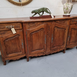 Parquetry top French oak Louis XV style sideboard with two draws and four cupboards. In good original detailed condition.