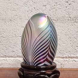 Iridescent glass egg shaped paper weight, on small wooden chinese stand. In good original condition. Please see photos as they form part of the description.