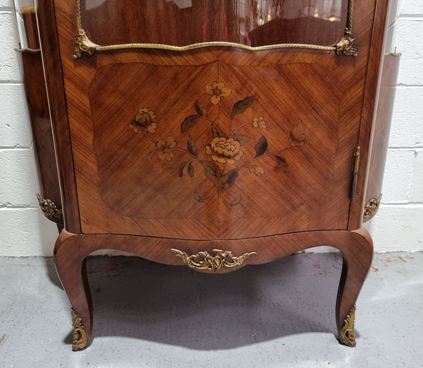 Grand French Walnut Louis XV style marble top vitrine. It has two glass shelfs and one mirrored shelf at the bottom and added storage at bottom. It is in good original detailed condition.