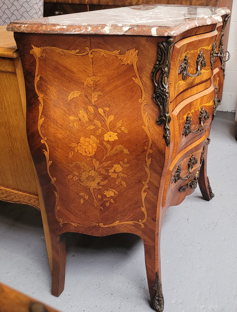 Antique French Louis XV style compact three drawer marble top commode with marquetry inlay and ormolu mounts. Sourced from France and in good original detailed condition.