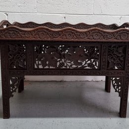 Anglo Indian folding occasional table with lift-up tray top. The tray has brass inlay and ornate carvings. The bottom of the table folds down and it is in good original condition.
