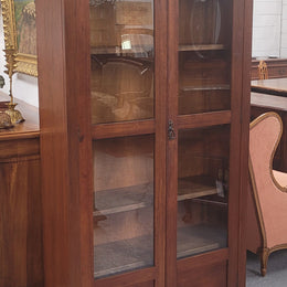 Beautiful two door Blackwood bookcase with glass doors and with four fully adjustable shelves. It is in good original detailed condition.
