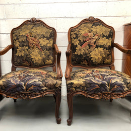 Pair of 19th Century French walnut tapestry covered arm chairs. They are in good original condition. Circa 1890.
