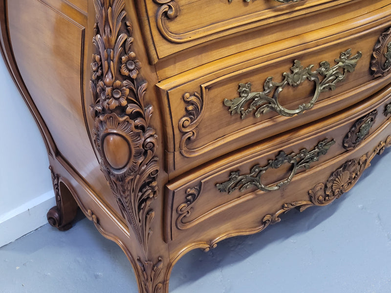 Impressive Louis XV style three drawer walnut commode. Ormolu handles and bevelled marble top complimenting detailed carving. In very good original detailed condition.