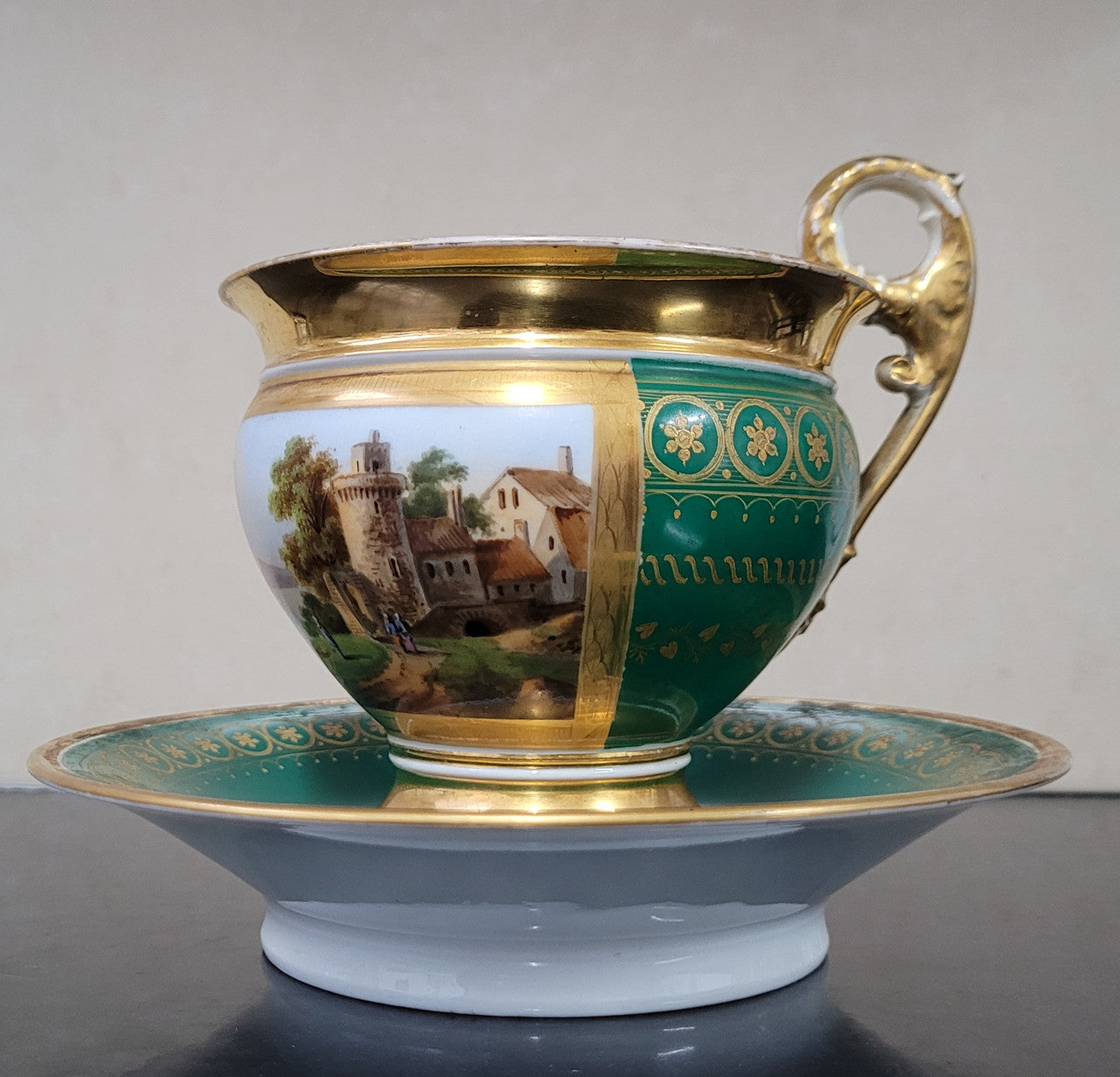 “Old Paris Porcelain” large cup and saucer with hand painted river landscape featuring castles. Gilt and enamel decoration. Circa: early 19th Century. In good original condition please view photos as they help form part of description.