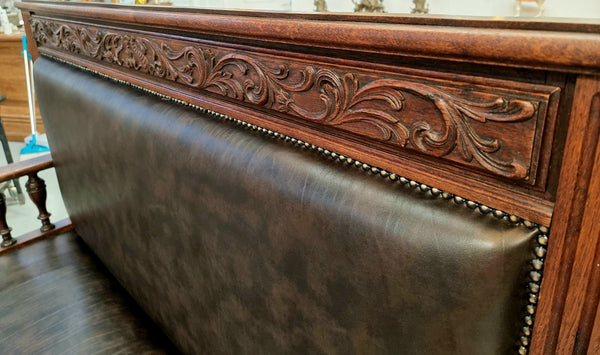 Superbly carved early 19th century newly upholstered French Oak hall seat of grand proportions and lovely details in good condition.