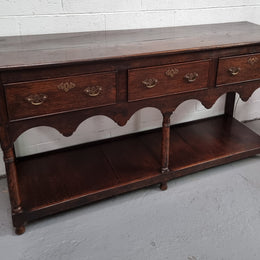 Antique 19th Century English dark Oak three drawer Dresser with brass handles and in good original condition.