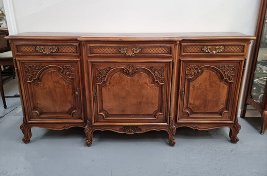 French Burr Walnut/Walnut parquetry top three door and three drawer sideboard. Plenty of storage space and beautiful decorative carvings. In good original detailed condition.
