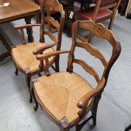 Pair of Louis XV Style Oak framed rush seated carver chairs. They have been sourced from France and in good original detailed condition.