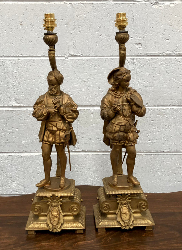 Fabulous pair of French gilt metal table lamps. One is of "The Artist" and the other of "The Sculptor". Lamps are wired to Australian standards and are in good original condition. Circa 1880.