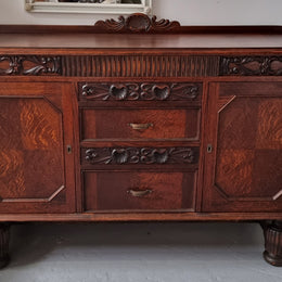 Art Deco Tudor style Oak sideboard with decorative carved detail. Plenty of storage space with two cupboards and four drawers. It has been sourced locally and is in good original detailed condition.