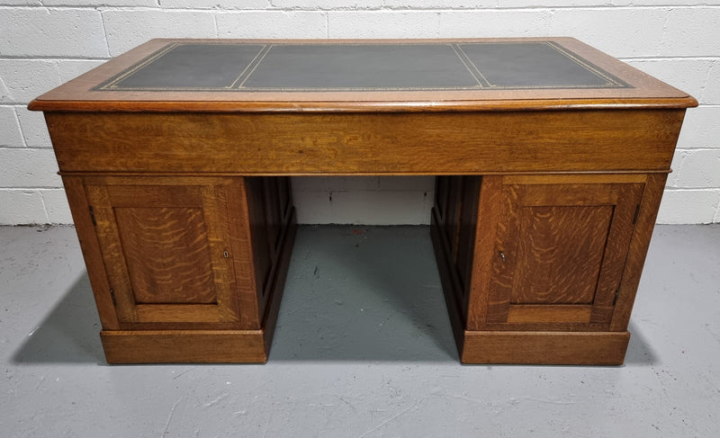 Amazing American Oak full partners leather top desk. Plenty of storage space with nine drawers on one side and two cupboards of the oppsite side. It is in good restored condition and has a new leather and gold tooled inset top.