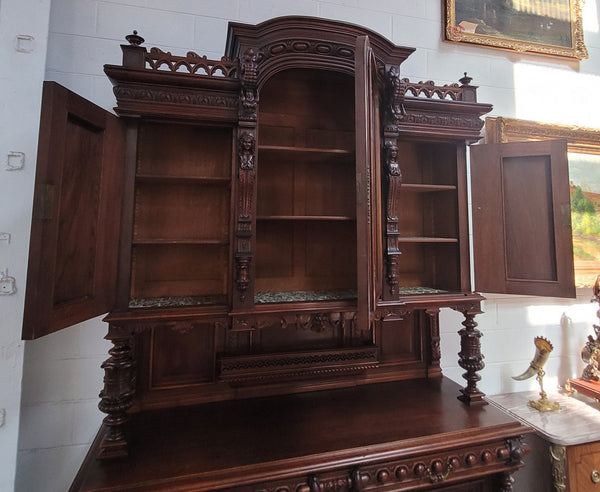 Spectacular French Walnut Renaissance Style buffet with amazing detailed carvings. Plenty of storage space with five cupboards and two large drawers. The three top cupboards open up to two adjustable shelves in each section and the two bottom drawers open up to one large fully adjustable shelve. In good original detailed condition.