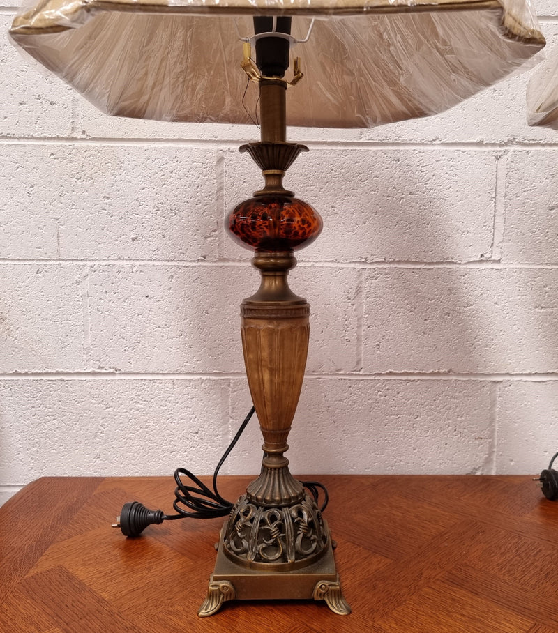 Beautiful pair of metal and glass lamp bases with new gold shades. They are in good original working condition and have been sourced locally.